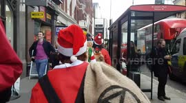 XR activists dress as Santa to deliver coal to Conservative Party HQ on eve of UK general election