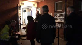 UK citizens queue up in dark to vote in first December election for nearly 100 years