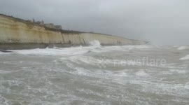 Waves crash over seawall in Brighton, UK