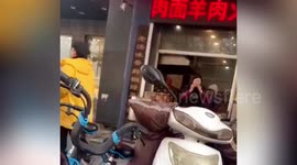 Chinese restaurant worker throws bone back into pan to cook after eating the meat off it
