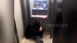 Alleged drunk man falls asleep beside ATM machine with cash scattered on ground