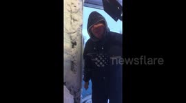 'Scraping the house as one does!' Man shovels thick layer of snow from his home after wild blizzard hits northern Iceland