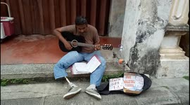 Malaysian handicapped street performer singing hope to get public donation 'FOR WALKING FURTHER'