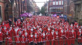 Hundreds don Santa suits for charity dash in Leeds in northern England