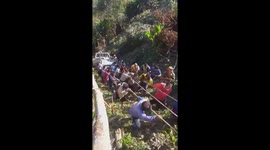 Hundred of locals help pull crashed truck back to mountain top in Thailand