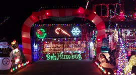 An over the top decorated house with Christmas lights and the most notorious disney characters all over. and wait for the end for a garage with a see through window displaying all sorts of christmas toys.