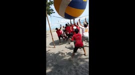 Staff play with giant volleyball for Christmas party in the Philippines