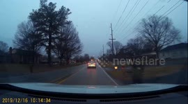Car blows past stopped bus loading kids