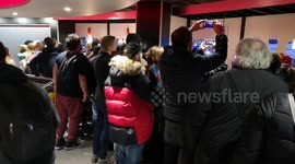 Determined fans crowd to watch Star Wars premiere from the window of nearby Burger King