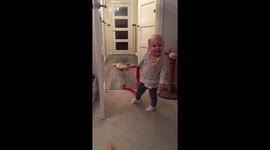 Toddler giggles as cat grabs tape!