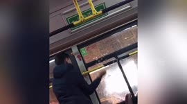 Chinese man smashes window and jumps out of bus that was waiting in traffic lights
