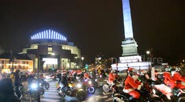 Annual charity event sees hundreds of bikers ride around Paris dressed as Santa Claus