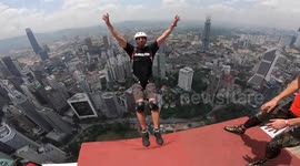 This is the stomach churning moment a crew of adrenaline junkies do freestyle stunt jumps off Kuala Lumpur Tower