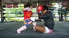 Cute but deadly: Thai boxing prodigy practices with father
