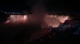 Frozen Niagara Falls lit up at night during the polar vortex!