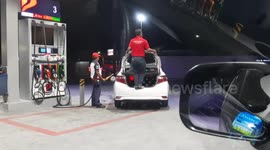 Driver Jumps On His Car While Refilling With Petrol