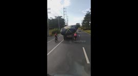Cyclists Ride Way Too Close Behind Truck