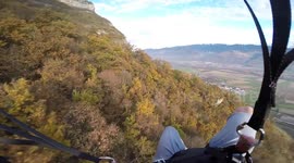 Aerial daredevil parachutes just inches above treetops speed-flying down French mountain