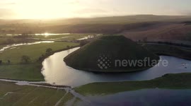 Beauty spot Silbury Hill in southwest England surrounded by a moat after  recent heavy rainfall