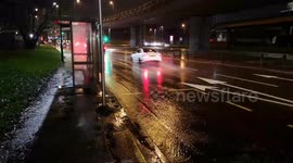 Heavy rainfall in London causes mini streams on the road