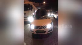 Tire smashes through car windscreen after falling off truck in China