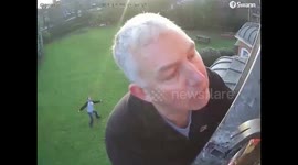 Dad fail! Father fixing security camera caught unaware as son makes fun of him behind his back