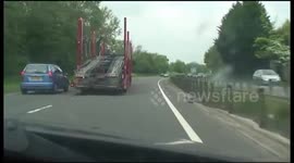 Car transporter's near miss with car in Swindon, southwest England
