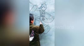 Chinese woman uses burnt wooden stick to draw Monkey King