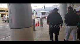 homeless woman walking around tom Bradley threatening with big scissors at lax