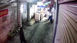 Group of pedestrians fall into sinkhole in Chinese back alley - including the same man TWICE!