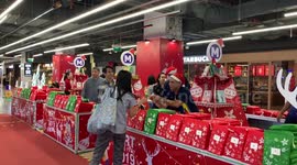 Subway passengers given free books for Christmas in Bangkok
