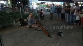Man performs musical performance using unique instrument