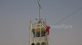 Santa Claus abseils down Thailand cathedral bell tower!
