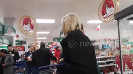 Shoppers On Christmas Eve Frantically Search Around Supermarkets