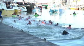 Crowds brave the water on Christmas morning in Weymouth, UK