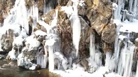 Huge icicles formed at waterfall in Drang Tangmarg, North Kashmir as a result of freezing temperatures