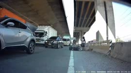 Strange moment Thai motorcyclists fails to navigate pebbles on highway and nearly gets hit