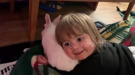 child loving on her pet bunny and cat