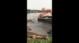 Excavator driver able to 'row' barge over river using crane