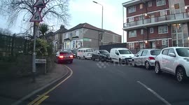 Learner on a mock tests makes a mistake overtaking cars stopped to give way to a bus coming down a hill in a very narrow road