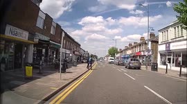 Boys walk out in front of a learner car then after learner passes in front of another car