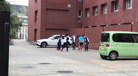 Japanese Fitness Fanatics Exercise In Car Park