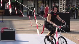 Double Unicycle Rider Amuses Audience