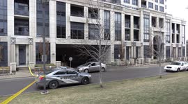 Toronto police at murder scene after reports of heavy machine gun fire at condo building and a dead body on the ground
