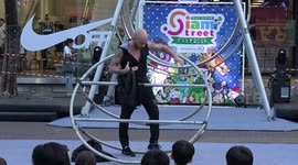 Cyr Wheel Acroboat Does Stunts On Metal Ring