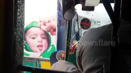 auto rickshaw driver helps by his foot with other auto rickshaw.