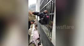 Alleged thief gets stuck between security bars in South China