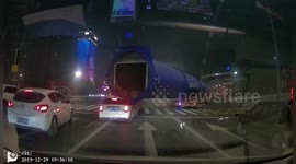 Giant pipe loaded on truck hits car and drags it forward several metres in China