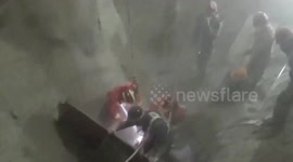Firefighters rescue worker buried in eight-metre-deep concrete storage tank after he accidentally fell