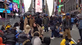 New Year's Eve revelers in New York pass through tight security and claim view points